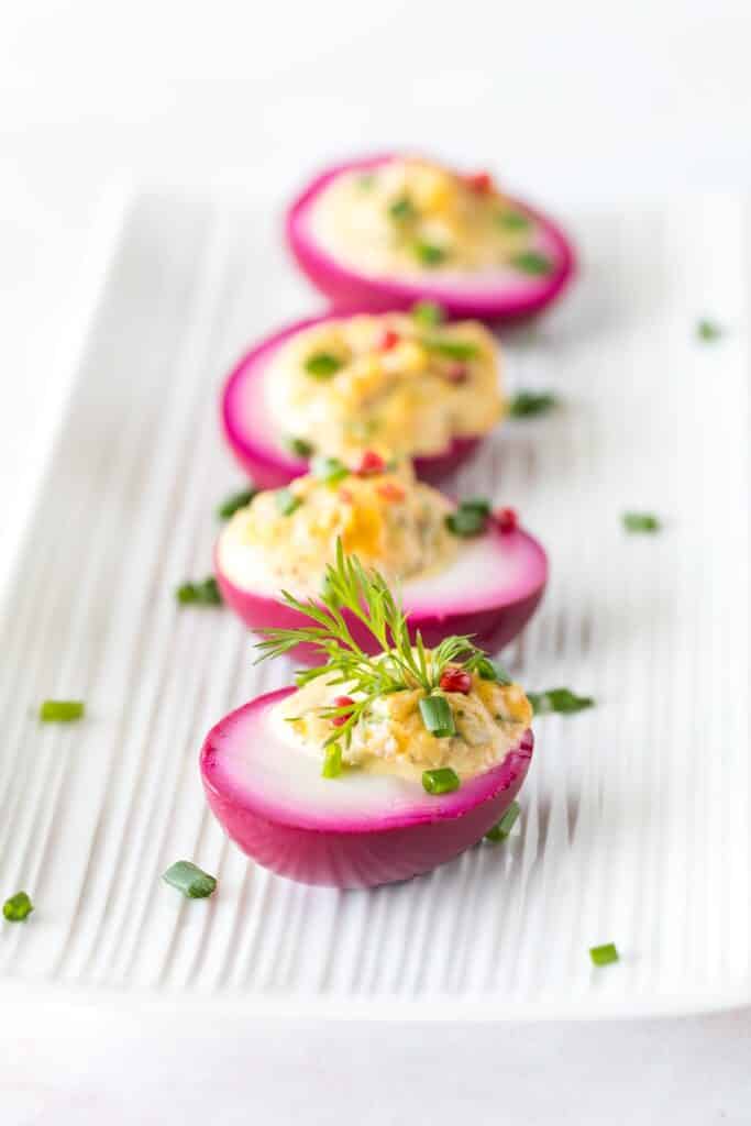A row of freshly made beet juice soaked devilled eggs for Easter | Aux Fourneaux Comment colorer des œufs durs naturellement avec de la betterave